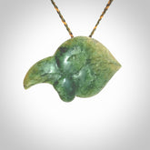 This picture shows a flower jade birds head. The bird is an extinct kokako - a saddleback that used to line in New Zealand's South Island. The cord is plaited and length adjustable. It is in two colours - khaki and burnt gold. We ship this worldwide.